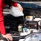 Cropped image of woman pouring windshield washer fluid