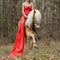 Cropped image of woman in red dress on a haflinger horse