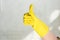 cropped image of woman in rubber glove showing thumb up while cleaning