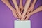 Cropped image of women putting girls hand into uv lamp