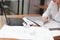 Cropped image of young business woman working with crumpled sheet on the workplace in office