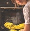 Cropped image of young girl cleaning the kitchen, learning to keep house clean