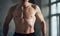 Cropped image of young man posing shirtless indoors. Relief, strong, muscular body shape. Attractive male body. Concept