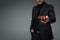 Cropped image of young man in suit holding gift box isolated on grey, international womens day concept