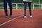 Cropped image of young sportsman and woman standing over shallow depth of field background