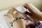 Cropped image of a young woman putting moisturizer onto her hand with very dry skin and deep cracks with cream