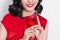 Cropped images of Young celebrating asian woman in red dress holding wine glass.