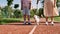 Cropped mother and son walking furry Maltese dog