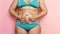 Cropped overweight fat woman pinching and hold tummy flabs, excess fat in blue underwear. Fast gain weight, cellulite.