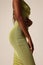 Cropped photo of African curvy woman body in green dress. Vertical mock-up.