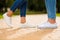 Cropped photo of charming pair legs walking green sunny day down park wear denim outfit