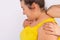Cropped photo of a chubby woman whose massage therapist uses her elbow to massage her neck and vertebrae. White