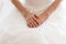 Cropped photo close up the bride sitting on a chair in a networked white dressing gown. morning of the bride