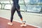 Cropped photo of disabled athlete woman with prosthetic leg in sportswear walking on the bridge