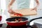 Cropped photo of housewife hands holding cutting wooden board checking meat condition adding fresh pepper cooking tasty