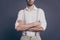 Cropped photo of macho business man arms crossed hiding half face strong hands dressed formalwear white shirt beige