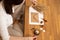 Cropped photo of woman hands making certificate present envelope craft, sitting at wood desk, holding paper, seal wax.