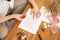 Cropped photo of woman hands making weeding invitation envelope craft, decorate adorn pink ribbon and seal wax. Hobby