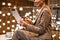 Cropped photo of woman using digital tablet while sitting at hotel restaurant