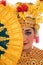Cropped picture of woman Balinese dancers standing hold a fan