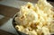 Cropped Popcorn in a silver bowl over wood background