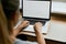 Cropped portrait of female employee typing on keyboard on generic laptop,