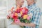 Cropped portrait of her she his he two nice cheerful cheery sweet tender people granny receiving big fresh tulips