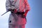 Cropped portrait of karate, judo sportsman in white kimono tying black belt isolated over gradient white blue background