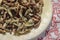 Cropped shoot of traditionally dried under sun string beans on plate with table sheet.