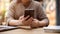 A cropped shot of an Asian woman responding to messages on her smartphone while sitting in a cafe