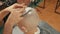 Cropped shot of barber shaving head of client with straight razor