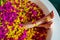 Cropped shot of barefoot woman with flowers, candles, colorful sea salt and bath for nails in beauty salon