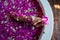 Cropped shot of barefoot woman with flowers, candles, colorful sea salt and bath for nails in beauty salon in Bali hotel