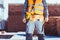 Cropped shot of builder in reflective vest and toolbelt standing