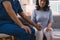 Cropped shot of caregiver is consulting with elderly woman, providing encouragement and taking a medical history. The