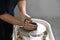 Cropped shot ceramicist creating handicraft crockery on the pottery wheel in workshop