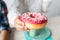 cropped shot of child holding doughnut at birthday party