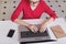 Cropped shot of concentrated female in eyewear keyboards on laptop computer. Talented successful freelancer updates application, u