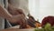 Cropped Shot Of Couple Cutting Vegetables For Salad Cooking Indoors