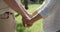 Cropped shot of elderly couple holding hands in park