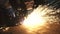 Cropped shot of a factory worker cutting steel with sparks flying around