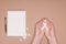 cropped shot of female hands with ribbon, pills and empty notebook