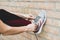 Cropped shot of female in sportswear and sneakers ready for training or running.