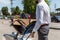 cropped shot of fired young manager with boxes on trolley cart at parking