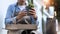 Cropped shot of gardener man holding cactus pot while sitting at garden.