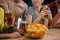 cropped shot of group of friends with beer and bowl of chips sitting at bar counter during watch of