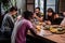 Cropped shot of a group of friends having a breakfast in the common kitchen, everyone is on their smartphone. Gadget