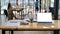 Cropped shot of laptop, notes and office supplies on a wooden desk in a comfortable shared workspace