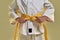 Cropped shot of little karate girl in white kimono adjusting yellow belt while getting ready for exercising, doing