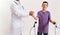 Cropped shot of male doctor shaking hands with teenaged disabled boy with cerebral palsy, taking steps using his walker